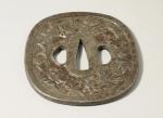 JAPON. TSUBA en fer à décor de chien et de...